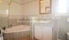 Badezimmer mit Eckbadewanne, Dusche, Waschtisch und Spiegel im Chalet Sa Coma, nahe Strand.