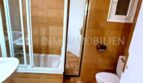 Badezimmer mit Badewanne, Glasabtrennung, WC und orangefarbenen Fliesen in Meereslinie-Wohnung El Arenal