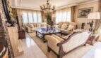 Elegantes Wohnzimmer der Villa in Marratxí mit klassischen Sofas, Marmorkamin und Kronleuchter