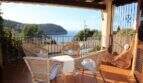 Überdachte Terrasse mit Korbmöbeln und atemberaubendem Meerblick auf die Bucht von Port de Sóller