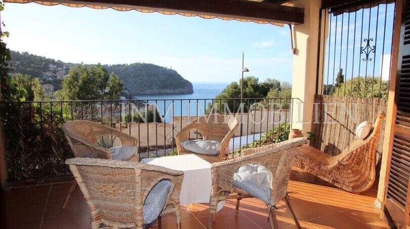 Überdachte Terrasse mit Korbmöbeln und atemberaubendem Meerblick auf die Bucht von Port de Sóller