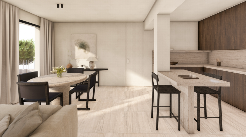Área abierta de estar-comedor con piso de mármol, mesa de piedra redonda y cocina moderna en Palma de Mallorca