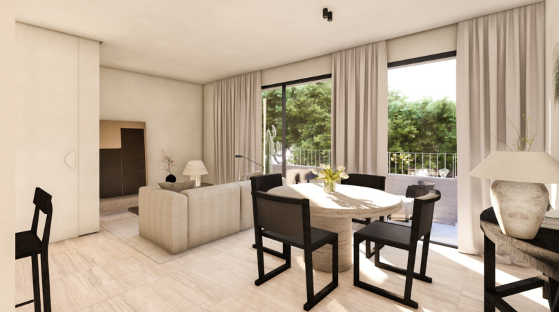 Sala luminosa con mesa de comedor, sillas negras y balcón con vistas al jardín en Palma de Mallorca
