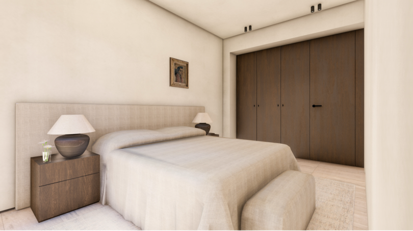 Dormitorio luminoso con cama doble, cabecero tapizado, mesitas de noche de madera y elegante armario empotrado en Palma de Mallorca.