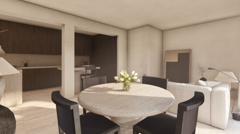 Área abierta de estar-comedor con mesa de mármol redonda, sillas oscuras y cocina abierta en Palma de Mallorca