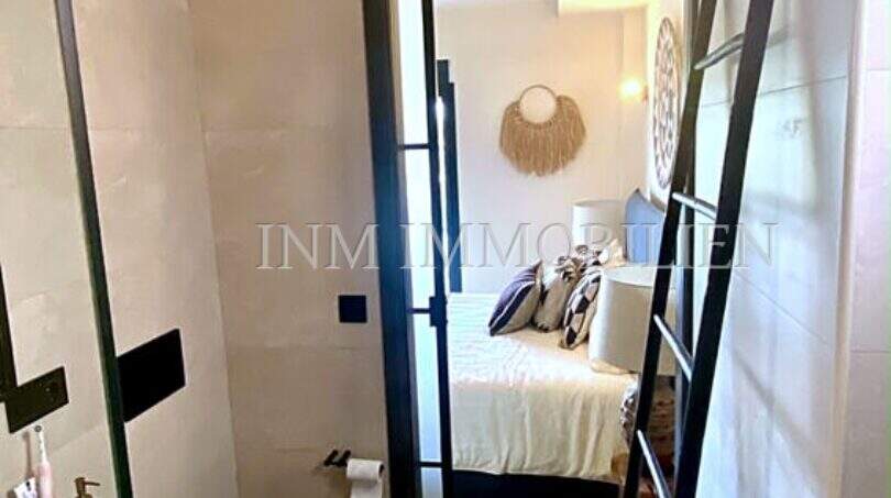 Modernes Badezimmer mit Blick ins Schlafzimmer, schwarze Akzente, helle Fliesen, Penthouse Playa de Palma