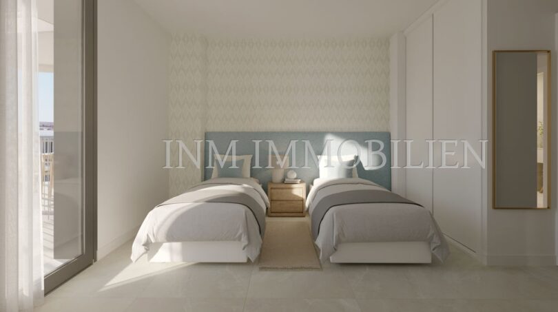 Dormitorio luminoso del apartamento áticos de nueva construcción en Palmanova con dos camas individuales, acceso al balcón y diseño moderno.