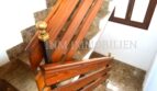 Elegant staircase with wooden railing and brass knob on marble steps in fully renovated apartment, Palma