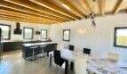 Open kitchen with dining area, wooden beam ceiling and modern fittings in high-quality finca in Campos