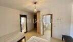 Bedroom of the Campos finca with two single beds, pendant light, built-in wardrobe and adjoining bathroom