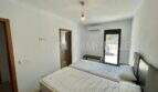 Bedroom of the Campos finca with two single beds, air conditioning, pendant light and access to outdoor area