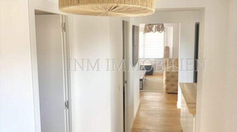 Heller Flur mit Holzboden, weißen Wänden und natürlichen Rattanlampen in renovierter Wohnung, Playa de Palma