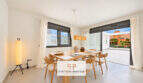 Helles Esszimmer im Penthouse Colonia de Sant Jordi mit Holztisch, Designlampe und Zugang zur Dachterrasse