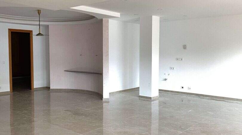 Leerer Wohnbereich mit Marmorboden, Rundbogen-Decke und großen Fenstern in exklusiver Hafenwohnung Porto Cristo