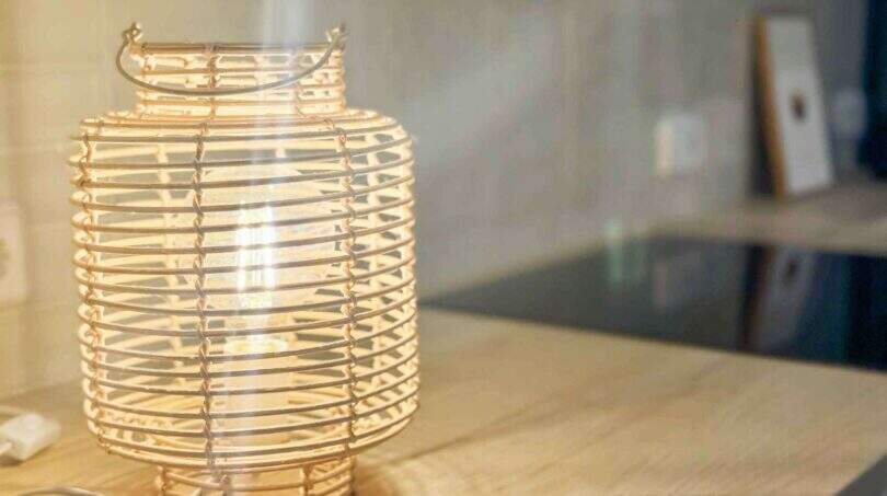 Rustikale Rattan-Tischlampe auf Holzablage im modern renovierten Stadthaus Felanitx