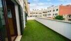 Spacious roof terrace with artificial turf and view of surrounding buildings, house in Felanitx
