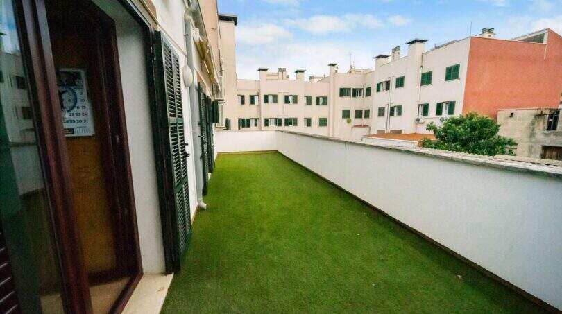 Spacious roof terrace with artificial turf and view of surrounding buildings, house in Felanitx