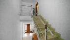 Bright stairwell with modern chrome railing and glass balustrade in house in Felanitx