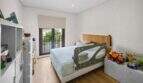 Children's room with single bed, bed guard rail, toys and balcony access with garden view in Felanitx