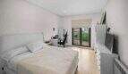Bright bedroom with double bed, desk, TV and balcony access in house in Felanitx