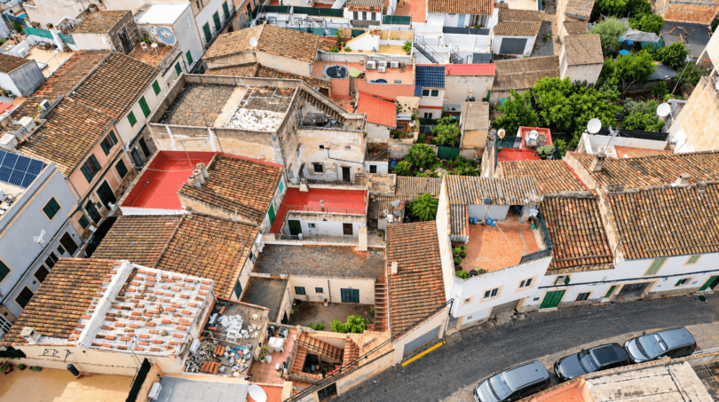 Aerial view of historic old town houses in Felanitx with terracotta roofs, terraces and courtyards