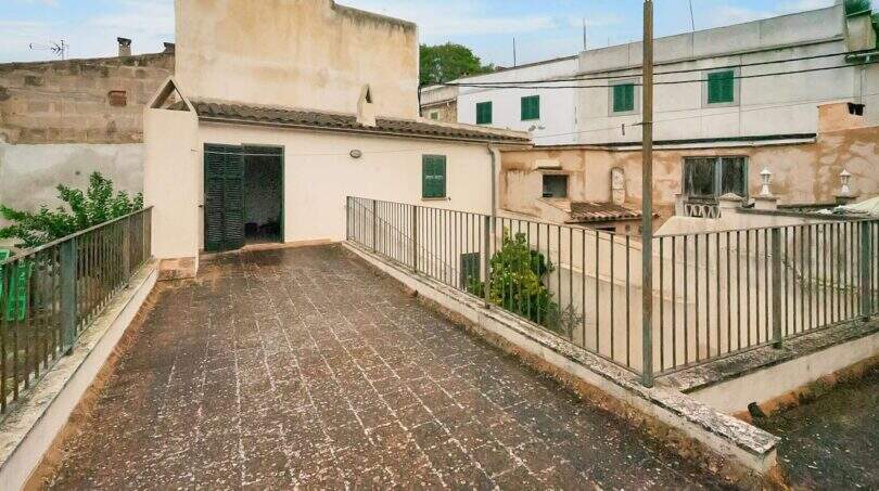 Roof terrace with metal railing and view of neighboring buildings, Felanitx townhouse