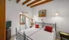 Bedroom with two single beds, wooden beam ceiling and Mediterranean charm in the 1900 town house in Felanitx
