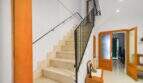 Bright staircase with marble steps, black iron railing and wooden doors in the historic townhouse in Felanitx.