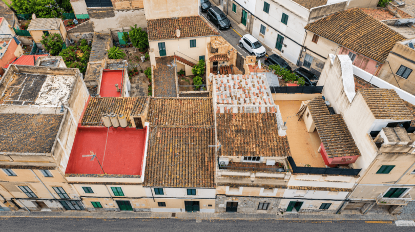 Aerial view of historic townhouses with terracotta roofs, terraces and courtyards in Felanitx, Mallorca
