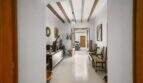Bright entrance hallway with wooden beam ceiling, vintage decor and view of garage in town house Felanitx