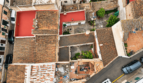 Aerial view historic townhouse Felanitx, terracotta roof, red terrace, courtyard with greenery, garage visible
