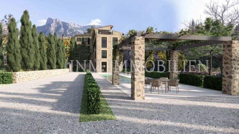 Vista exterior finca rústica Valle de Sóller con muros de piedra natural, pérgola, piscina y panorama montañoso