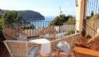 Sonnige Terrasse mit Rattanmöbeln und atemberaubendem Meerblick auf die Bucht von Port de Sóller