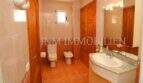 Bright bathroom of the finca near Campos with toilet, bidet, sink and wooden elements.