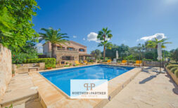 Finca Felanitx: Mediterranean Pool with Natural Stone Terrace, Palms and Rustic Country House under Blue Sky
